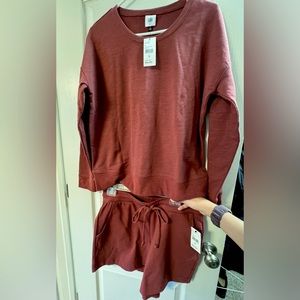 New with tags. Cabi training sweatshirt and shorts set.  Burgundy. Size medium